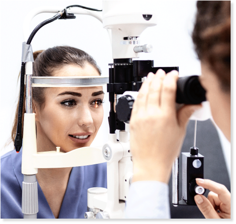 eye doctor performs eye exam on patient