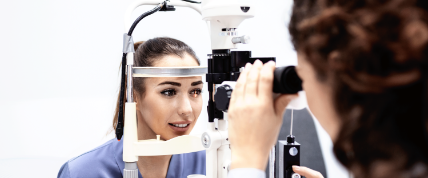 eye doctor performs eye exam on patient